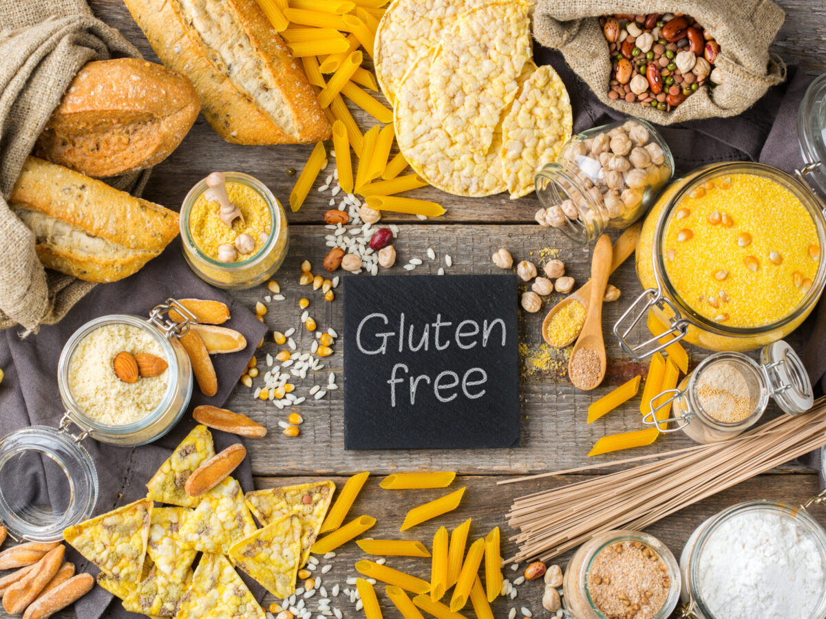Healthy eating, dieting, balanced food concept. Assortment of gluten free food and flour, almond, corn, rice on a wooden table. Top view flat lay background
